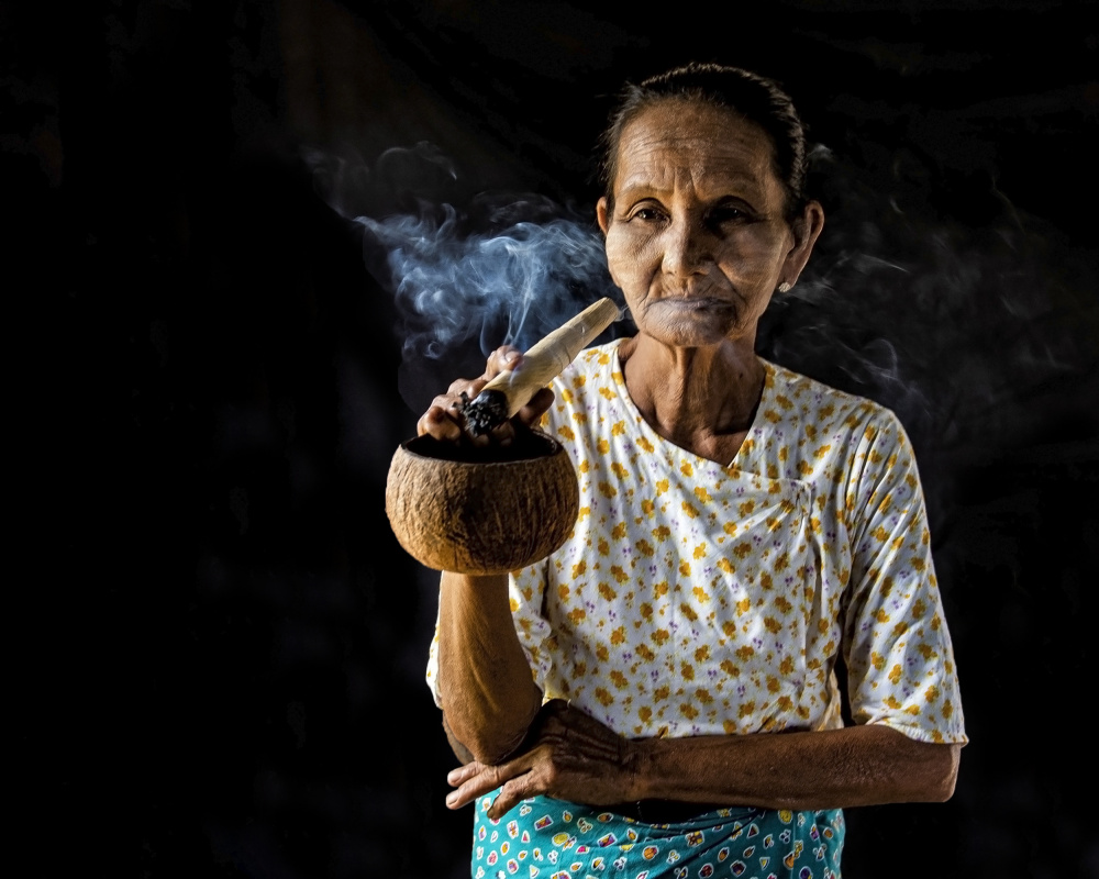 Woman smokes cigar, Bagan, Myanmar from Aharon Golani