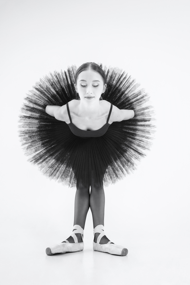 peacock. a ballerina in a black tutu is leaning forward with her arms crossed behind her back from Alexandr