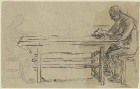 Lesender Mann an einem Tisch