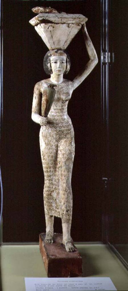 Female bearer of offerings carrying a water vase in her hand and a vessel on her head from Egyptian