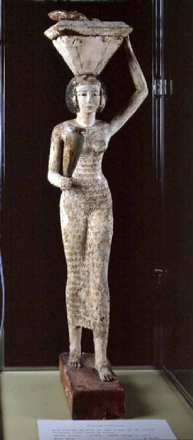 Female bearer of offerings carrying a water vase in her hand and a vessel on her head
