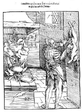 View of a sixteenth century kitchen with cook gutting a rabbit