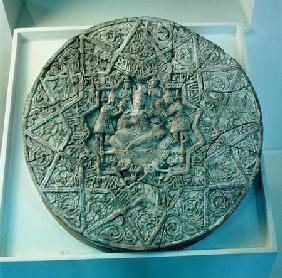Sun disc depicting a king sitting cross-legged on a throne flanked by two angels in the centre, foun