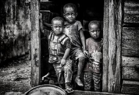 hree children about to leave their home - GhanaChildren in their home - Benin