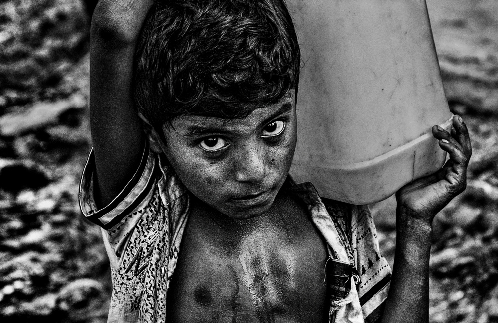 Refugee child carrying a container of water from Joxe Inazio Kuesta Garmendia