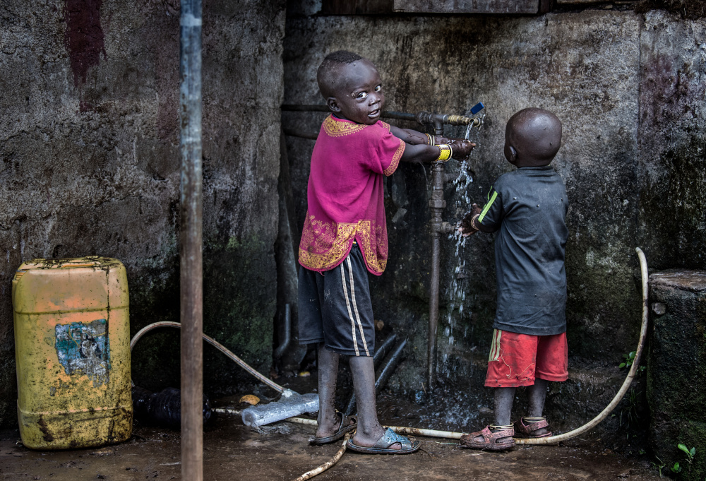 Surmi tribe children cleaning their hands before starting to eat - Ethiopia from Joxe Inazio Kuesta Garmendia
