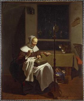 Woman at candlelight doing needlework.