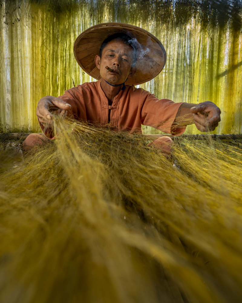 A fisherman preparing his nets ready for the next Catch from Mahendra Bakle