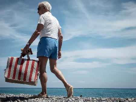 Man with red striped sun mattress