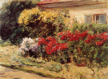 shrubs of flowers in front of the cottage of the gardener from Max Liebermann