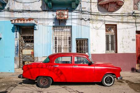 Red Oldtimer in Havana, Cuba. Street in Old Havana