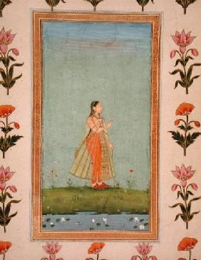 Lady holding a flower, standing by a lily pond, from the Small Clive Album