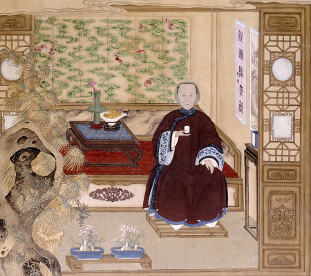 A Lady In Dark Red, Seated On A Day Bed Holding A Blue And White Cup from 