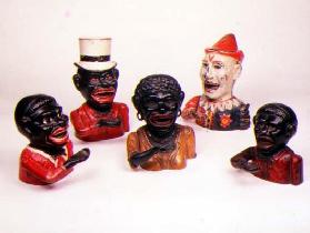Group of Mechanical cast iron money banks. Left to right: Jolly Nigger with Butterfly Tie, Jolly Nig