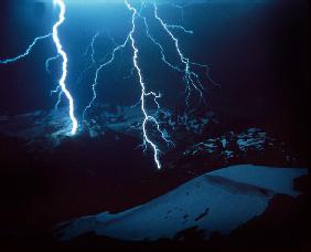 Lightning during a storm over snowy mountains