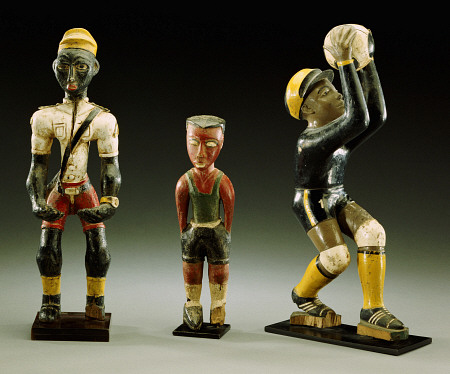 Three Male Carved Figures, One Wearing An Official''s Uniform, The Other Two In Sports Gear from 