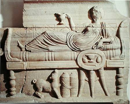 Detail from a sarcophagus depicting a woman reclining on a bench from Roman