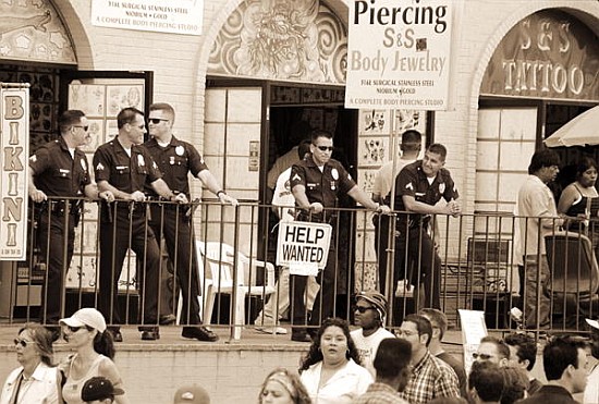 Police gathered behind a ''Help Wanted'' sign, 2004 (b/w photo)  from Stephen  Spiller