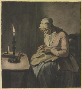 Frau im Kerzenschein bei der Handarbeit